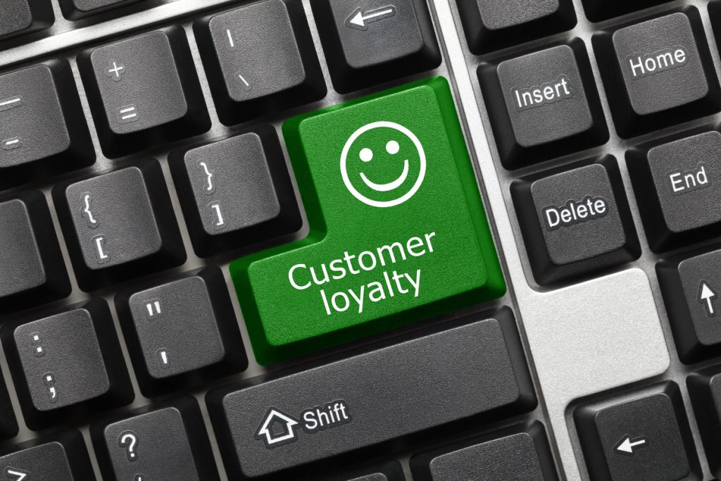 Close-up view on conceptual keyboard - Customer loyalty (green key)