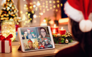 Christmas Eve etiquette | photo of ipad with zoom or facetime call, family members and friends wearing Christmas attire