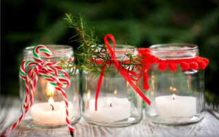 reduce holiday stress | three mason jars decorated for the season with candles