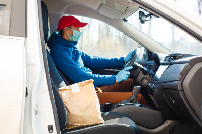 how much should you tip delivery drivers | man in red hat and blue coat making a food delivery