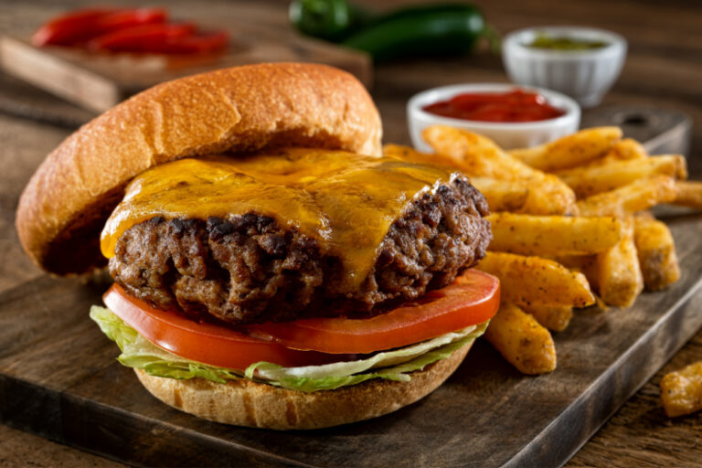 finger food etiquette | cheeseburger and fries on wooden tray