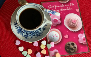 Valentine's Day Celebration | Cup of coffee and candy hearts with card