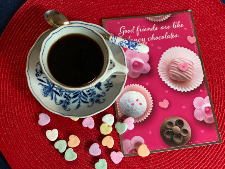 Valentine's Day Celebration | Cup of coffee and candy hearts with card