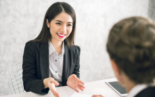 what are soft skills? Woman at job interview smiling