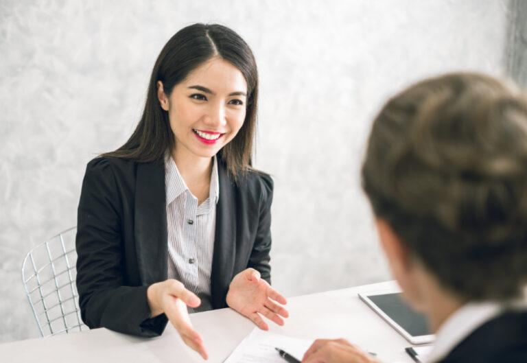 what are soft skills? Woman at job interview smiling