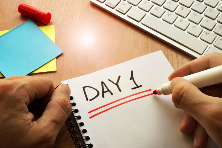 first day at a new job | notepad, sticky notes and keyword with words "day 1" written in marker on paper