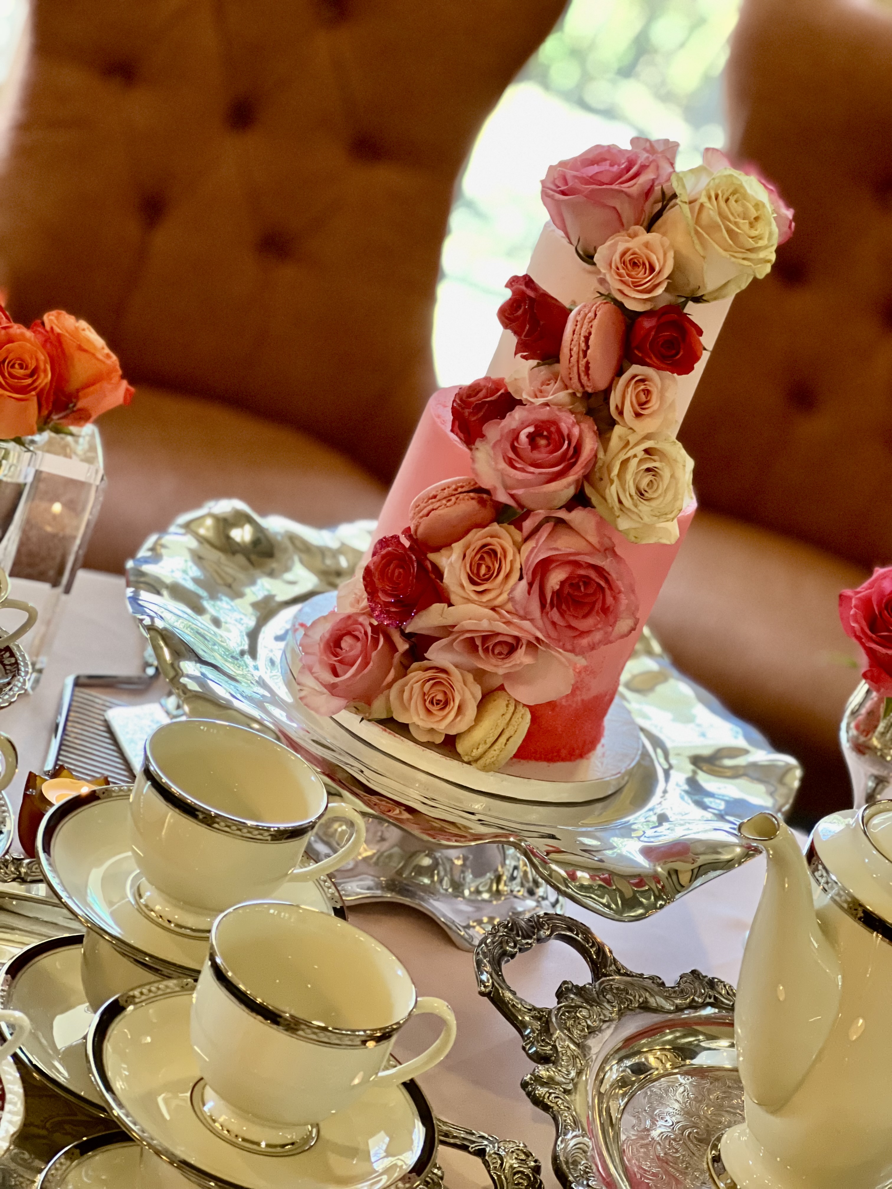 beautiful cake decorated with roses at the tea table