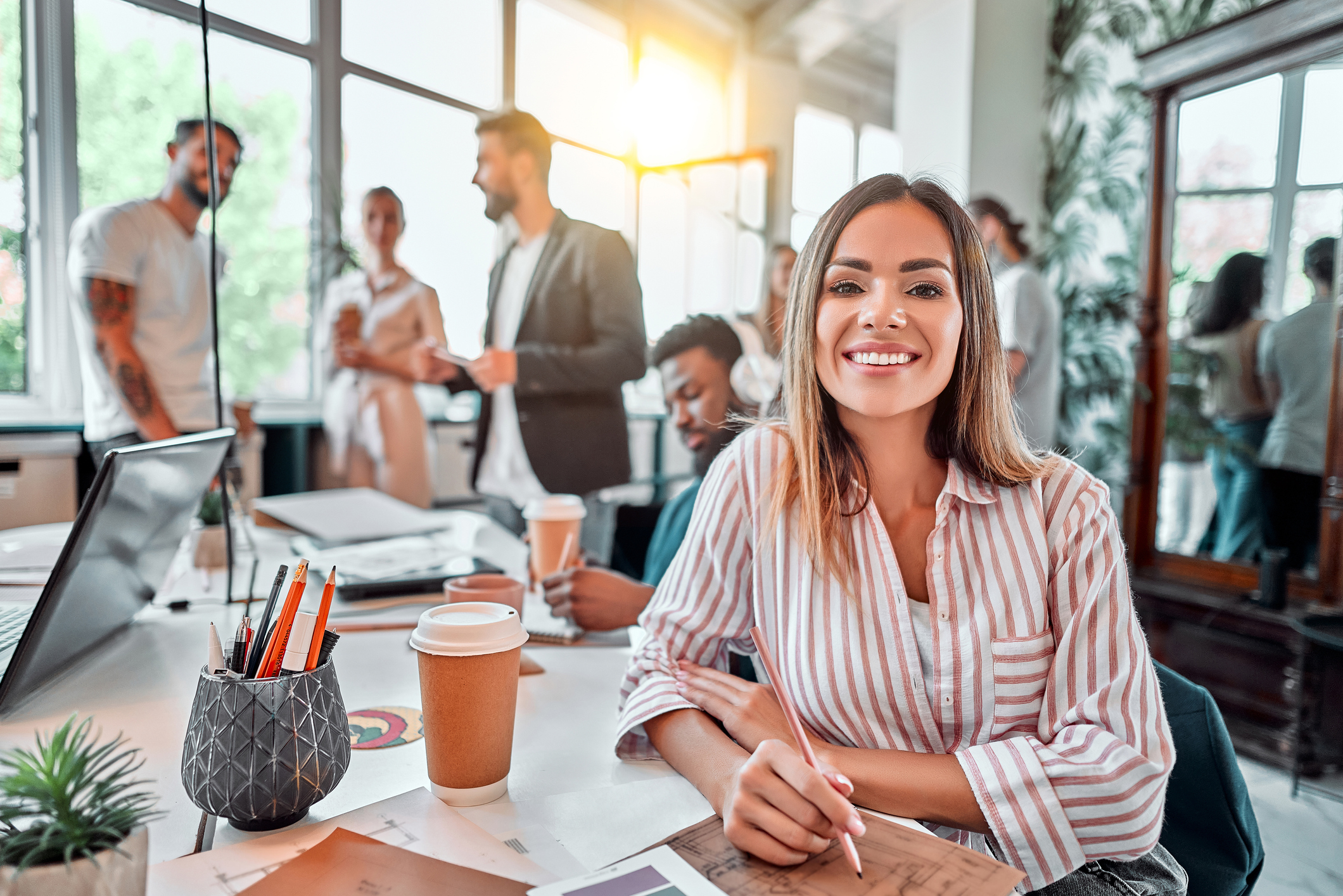 How To Know if Your Job Is Right for You | Smiling female employee sit in coworking space and working on the project. Front view