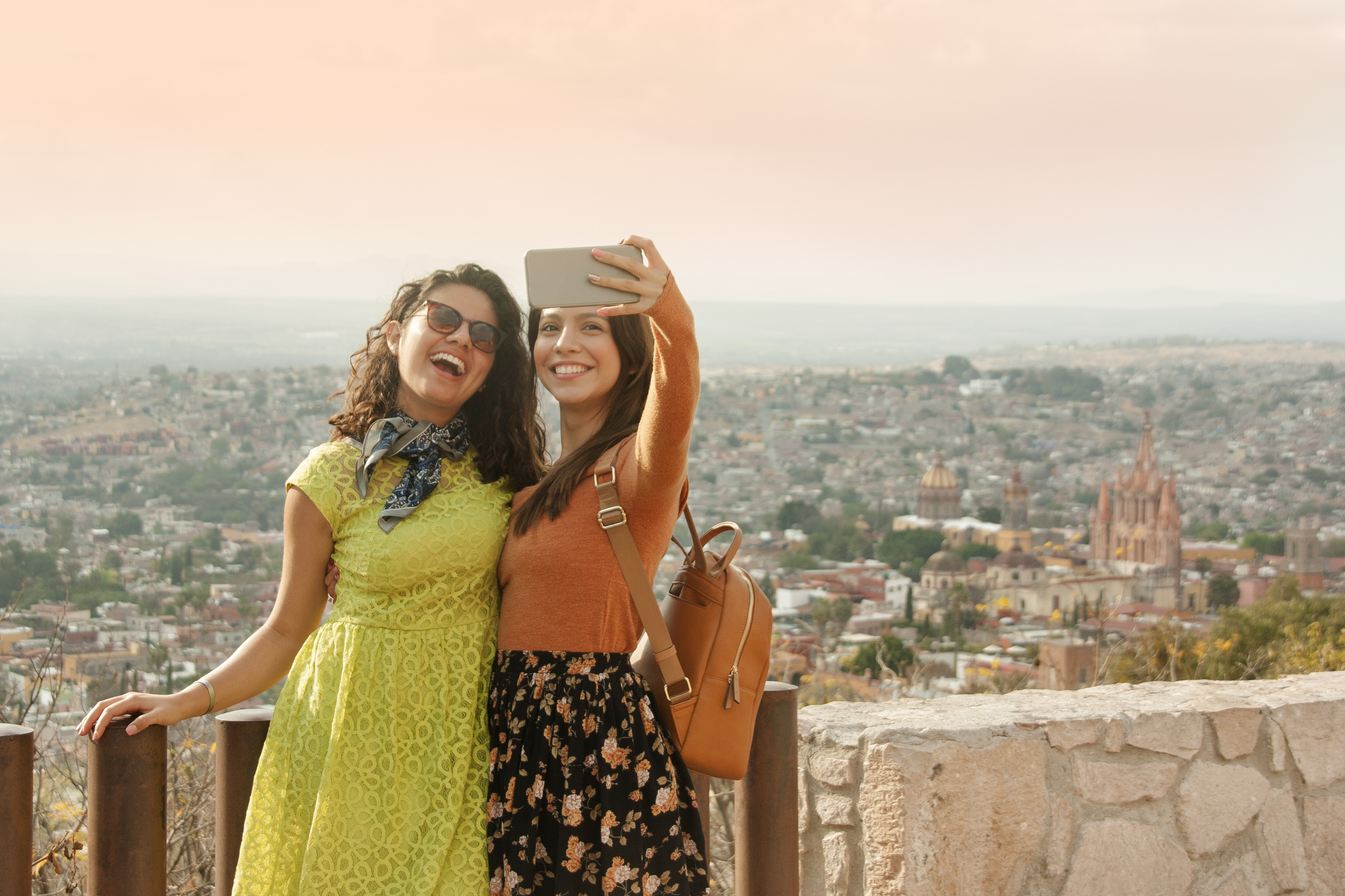 2022 travel etiquette | Friends taking a selfie at a viewpoint in San Miguel de Allende, Mexico