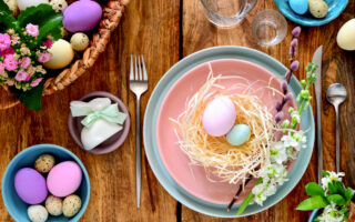 Easter Entertaining Tips | Beautiful Easter place setting with a faux nest and eggs on a pink plate with a blue saucer