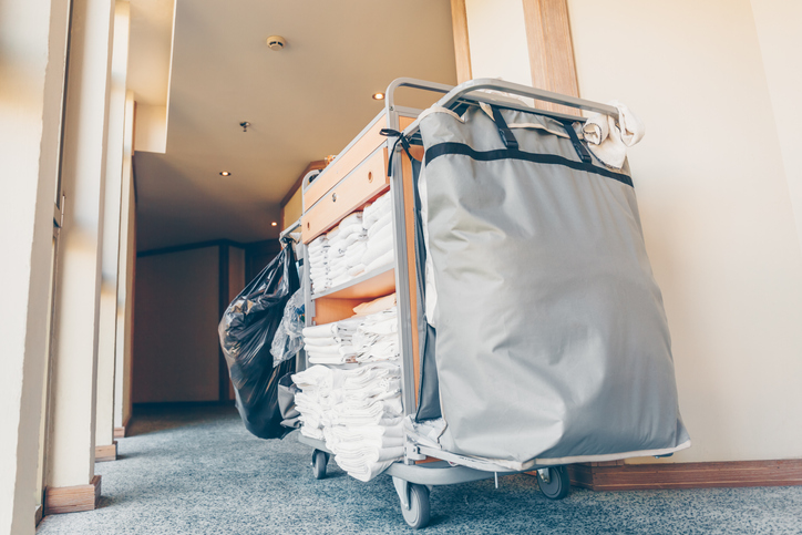 Housekeeping cart in the hotel corridor. Horizontal, light blue toning