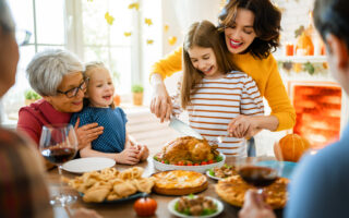 no-phone zone at the holiday table | Happy Thanksgiving Day! Autumn feast. Family sitting at the table and celebrating holiday. Grandparents, mother, father and children. Traditional dinner.