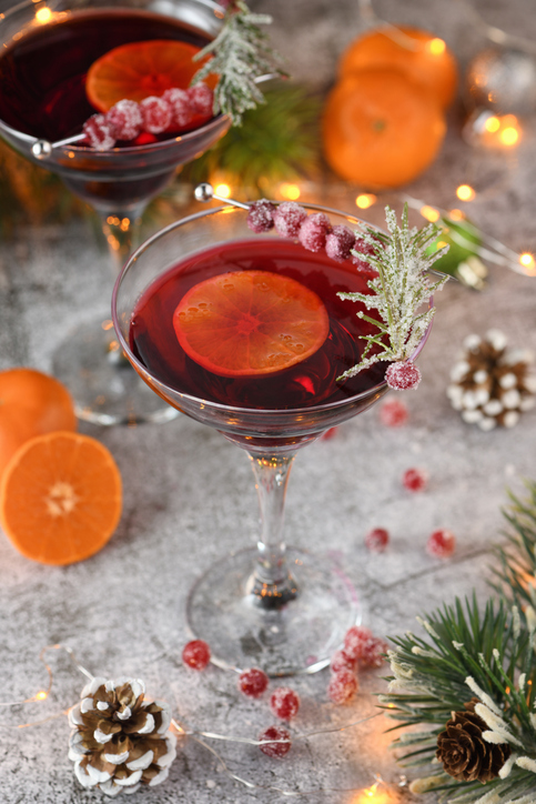 holiday cocktail recipe | Goblet with cranberry Margarita with candied cranberries, rosemary and tangerine. Perfect cocktail for a Christmas party