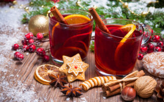 Christmas Tea thoughts from etiquette expert Diane Gottsman | Two glasses of mulled wine with christmas decoration