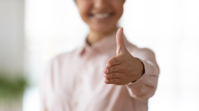 How to stand out in the business world | Cropped close up image happy indian woman reaching out hand, ready for cooperation. Smiling younf female professional specialist propose agreement, or welcoming greeting new clients partners.