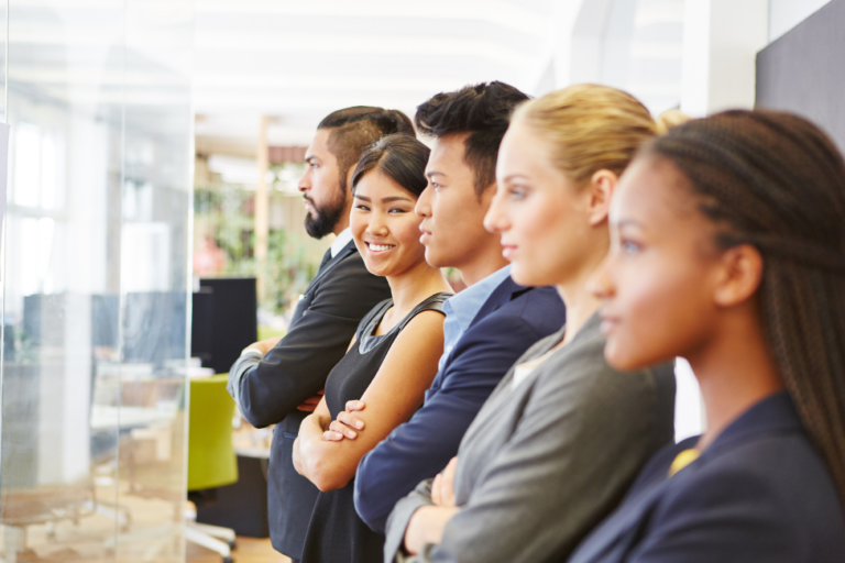 What Matters Most to Gen Z In the Workplace | group of Gen Z employees in business attire, side profiles