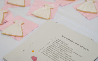 wedding shower etiquette questions | table with bridal shower cookies and a game to play