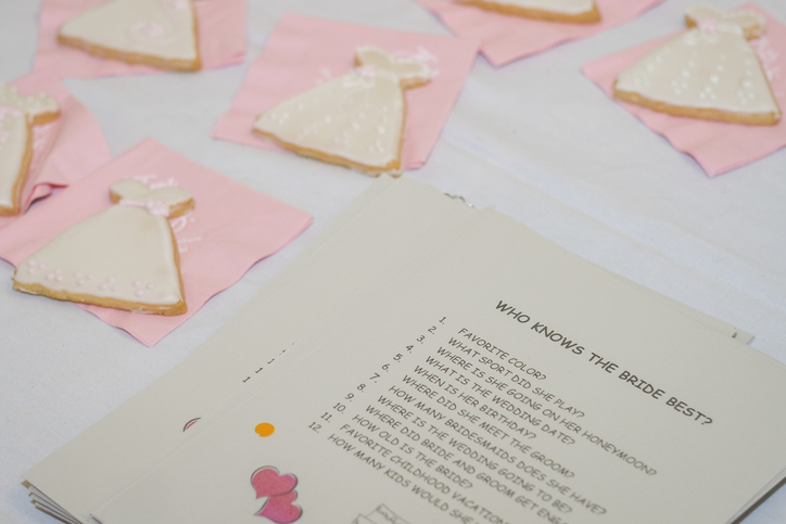 wedding shower etiquette questions | table with bridal shower cookies and a game to play