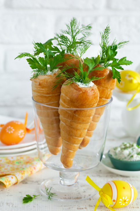 Easter Stuffed Crescent Roll Carrots. Cooking and baking idea for festive dinner. White background, selective focus