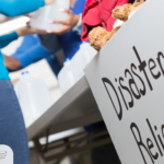 How to help after a natural disaster | team of volunteers at a disaster relief stand