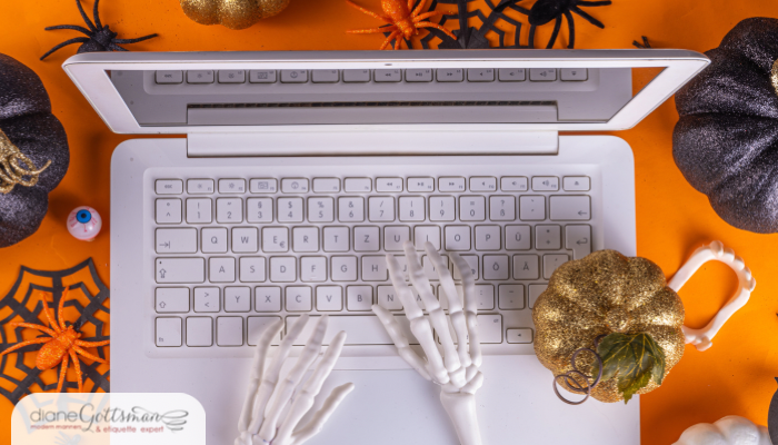 Halloween office party etiquette | plastic skeleton hands on laptop, orange background