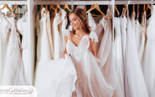 etiquette for canceling a wedding | bride-to-be trying on wedding gowns in a bridal shop