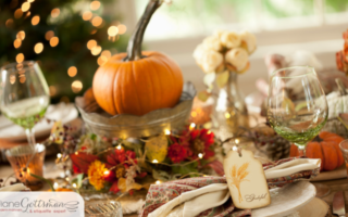 Thanksgiving Host Etiquette | table set for Thanksgiving with pumpkins, flowers, and lights