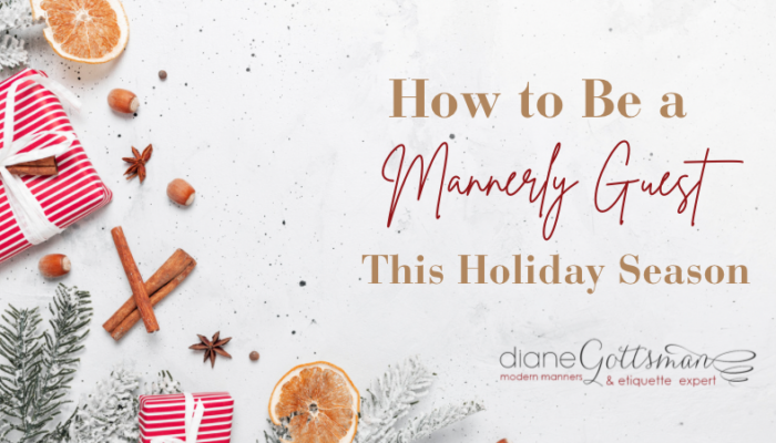 how to be a mannerly guest this holiday season | holiday flat lay with red and white gift and dried orange slices