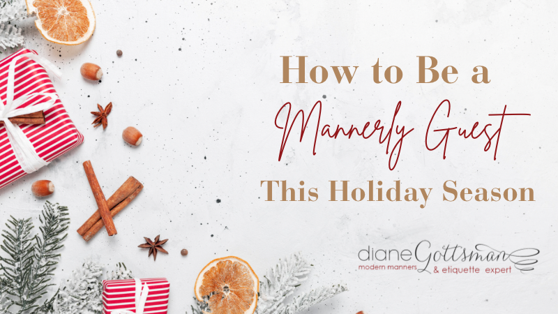 how to be a mannerly guest this holiday season | holiday flat lay with red and white gift and dried orange slices