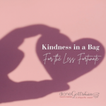 Kindness in a bag | helping the less fortunate | etiquette expert Diane Gottsman | shadow of hand holding paper heart on pink background