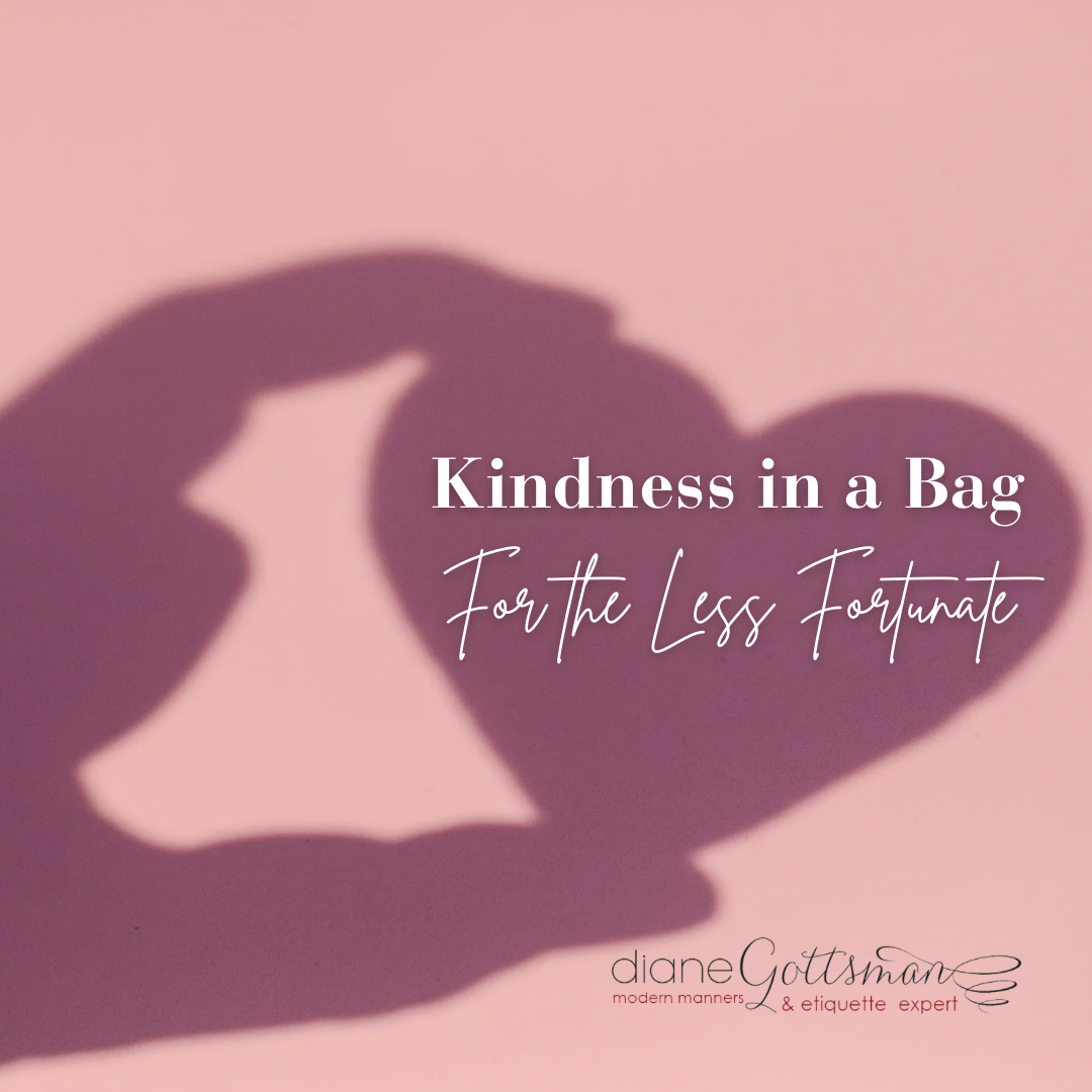 Kindness in a bag | helping the less fortunate | etiquette expert Diane Gottsman | shadow of hand holding paper heart on pink background