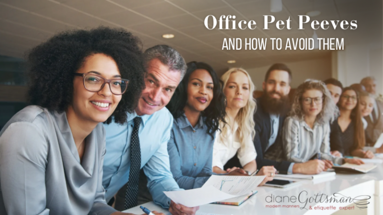 Office Pet Peeves in 2025 | Group of coworkers looking at camera, sitting at long table