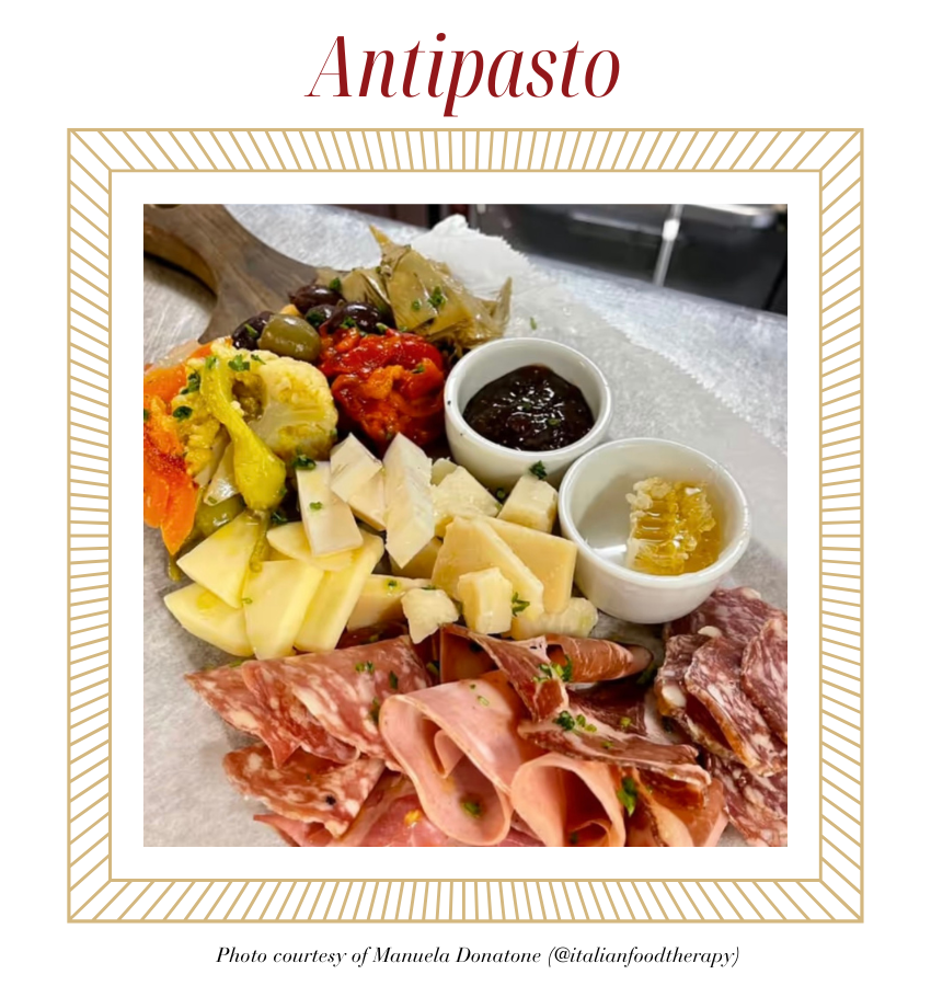 Antipasto on wooden tray in kitchen