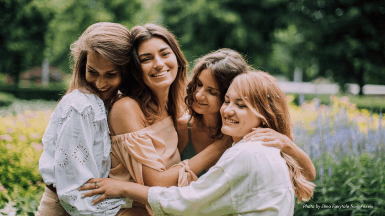 group of adult girlfriends outdoors in neutral colored clothing and hair down | adult friendship etiquette