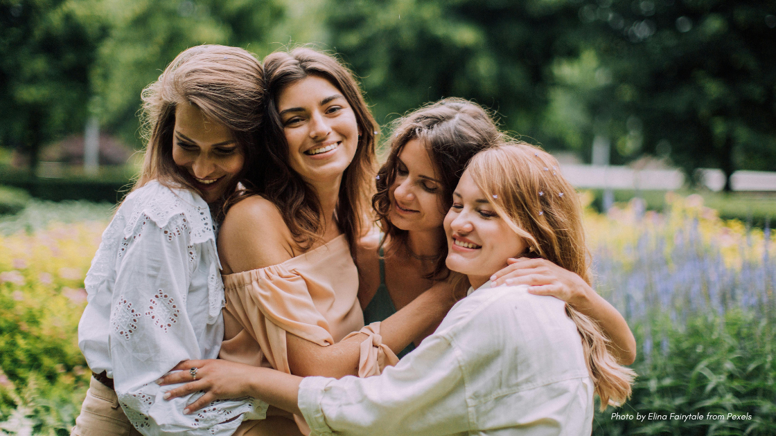group of adult girlfriends outdoors in neutral colored clothing and hair down | adult friendship etiquette