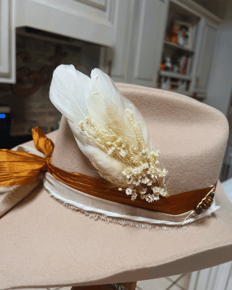 cowboy hat etiquette | beautiful cream colored cowboy hat with ribbon and dried flowers
