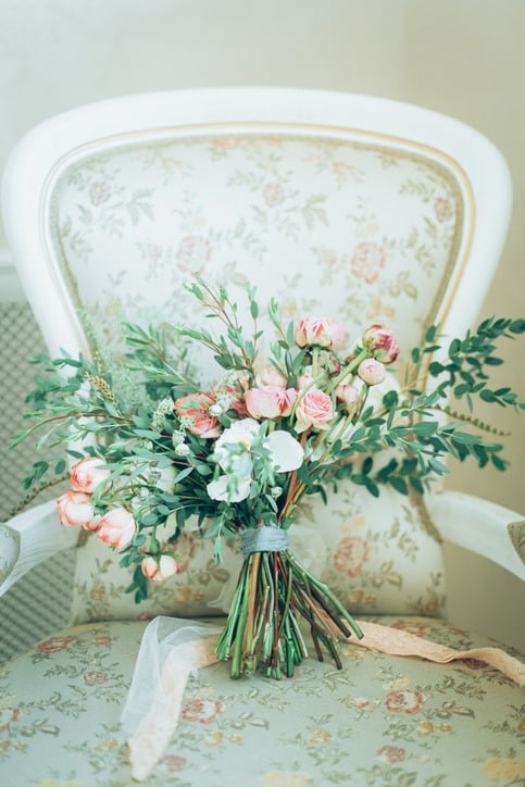 Rustic spring bridal bouquet on classic ivory chair