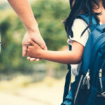 Back to school for grown-ups | Child with backpack holding her mother's hand and going to school in vintage color tone