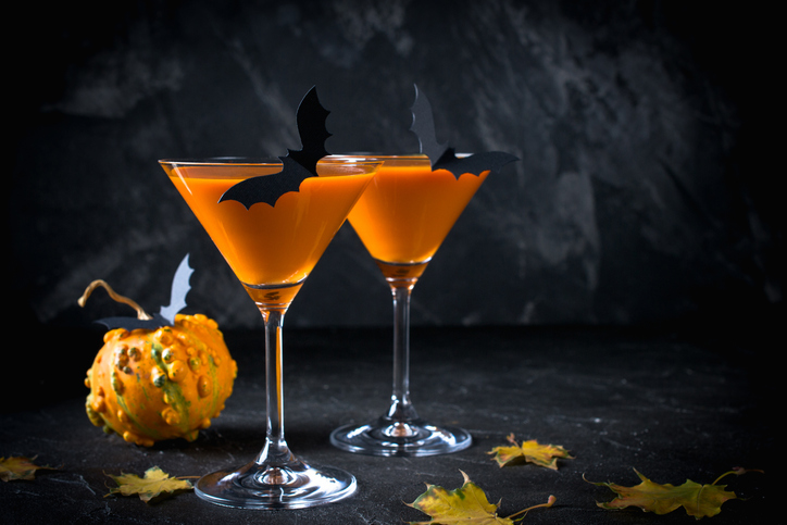 Halloween party etiquette | Halloween pumpkin orange cocktails. Festive drink. Halloween party. Funny Pumpkin with holiday decorations